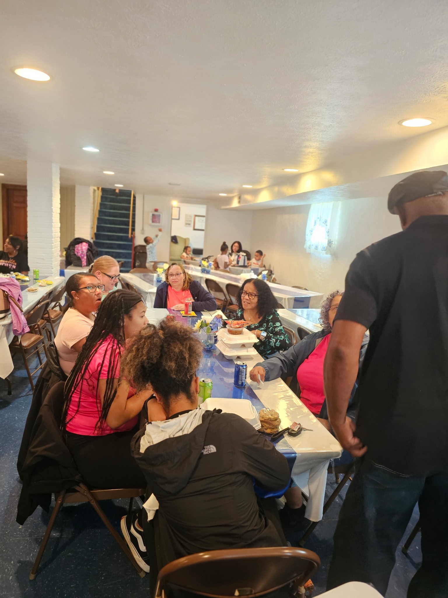 People in supportive conversation at church community table